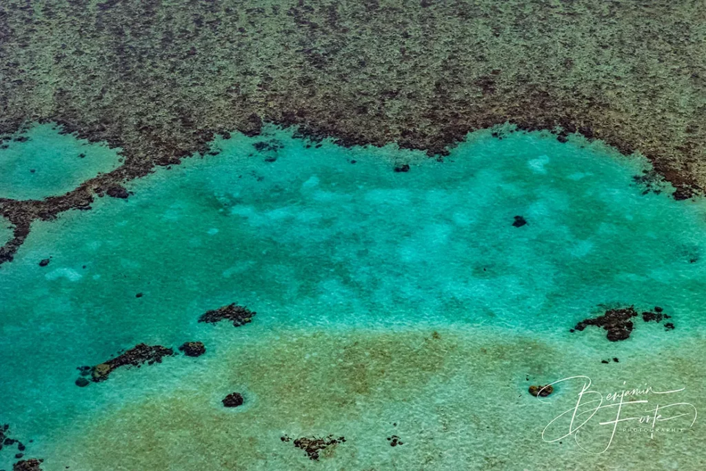Aerial view of a coral reef and its turquoise lagoon